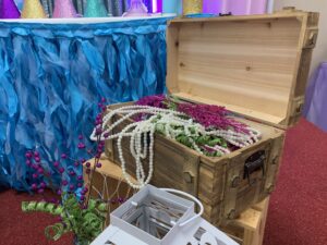 A wooden trunk with some flowers in it