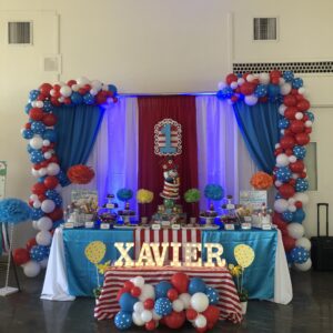 A table with balloons and decorations in the shape of seuss characters.