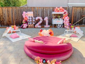 A pink donut pool float in the shape of number 2 1.