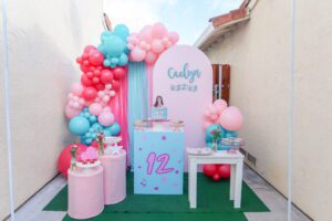 A table with balloons and chairs in front of it
