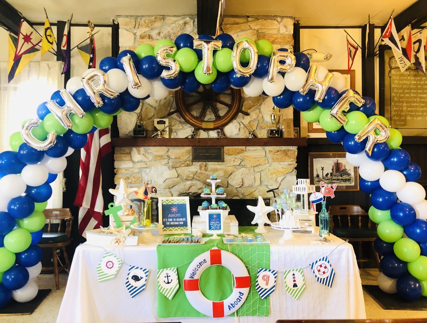 A table with decorations and balloons in the shape of boats.