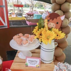 A table with cupcakes and flowers on it