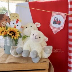 A table with some stuffed animals and sunflowers