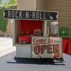 A red truck with a sign that says rock n roll.