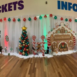 A room with gingerbread houses and trees on the wall.
