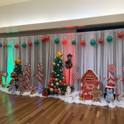 A room with christmas decorations and lights on the wall.