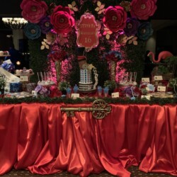 A table with red cloth and flowers on it