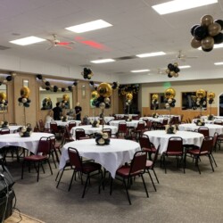 A room with many tables and chairs in it