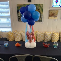 A table with balloons and a balloon elephant.