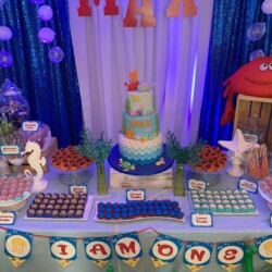 A table with a cake and many different candies