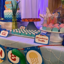 A table with a cake and other desserts on it