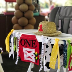 A table with a cowboy hat and decorations on it.