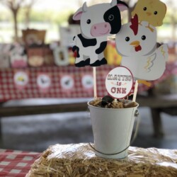 A table with hay and farm animals on it