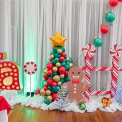 A christmas themed party with balloons and decorations.