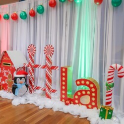 A room with white curtains and red decorations.