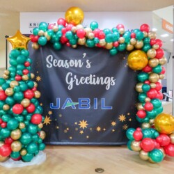 A large sign with balloons and christmas decorations