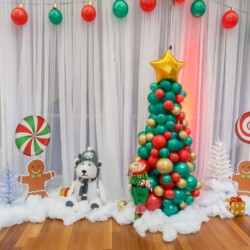 A christmas tree made out of balloons and gingerbread men.