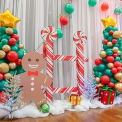 A christmas themed photo booth with balloons and decorations.