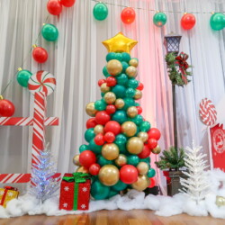A christmas tree made of balloons and presents.