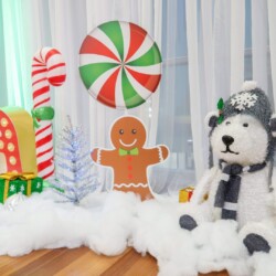 A table with a white dog and gingerbread man.
