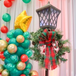 A christmas tree with balloons and decorations on it.