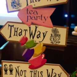 A stack of signs that say " alice in wonderland ".
