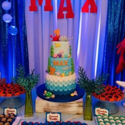 A table with a cake and many different types of food