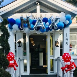 A house with balloons and balloons on the front of it.