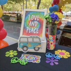 A table with a vase of flowers and a picture.