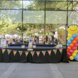 A table with many different colored balloons on it