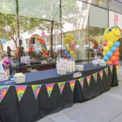 A table with balloons and candles on it