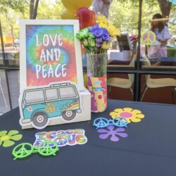 A table with flowers and a sign that says love and peace.