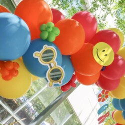A bunch of balloons that are in the shape of a face
