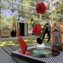 A table with a record player and some roses