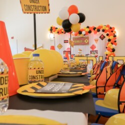 A table with construction themed decorations and hats.
