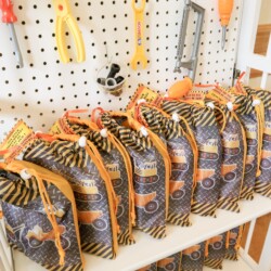 A row of bags on display in front of a wall.