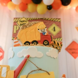 A close up of the cake with construction themed decorations.
