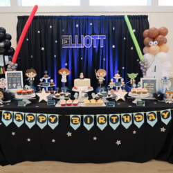 A table with a star wars themed birthday party.