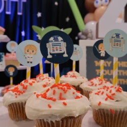 A table topped with cupcakes covered in frosting.