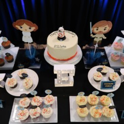 A table with cupcakes and cake on it