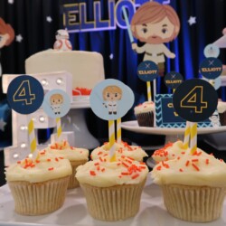 A table with three cupcakes on top of it.