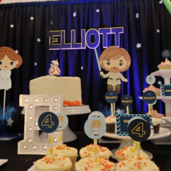 A table with cupcakes and decorations on it