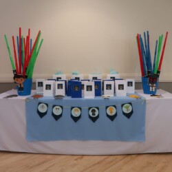 A table with a white cloth and many cups