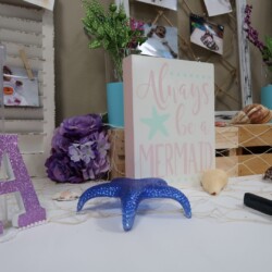 A table with a blue star and some purple flowers