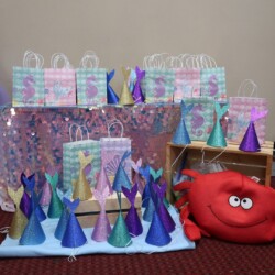 A table with party hats and bags on it