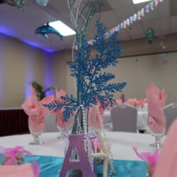 A table with pink and blue decorations on it