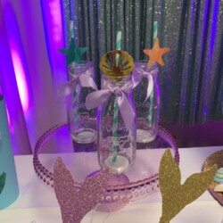 A table with three bottles and two stars on it.