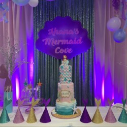 A table with a cake and balloons on it