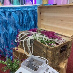 A wooden trunk with some flowers in it