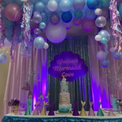 A table with balloons and decorations on it